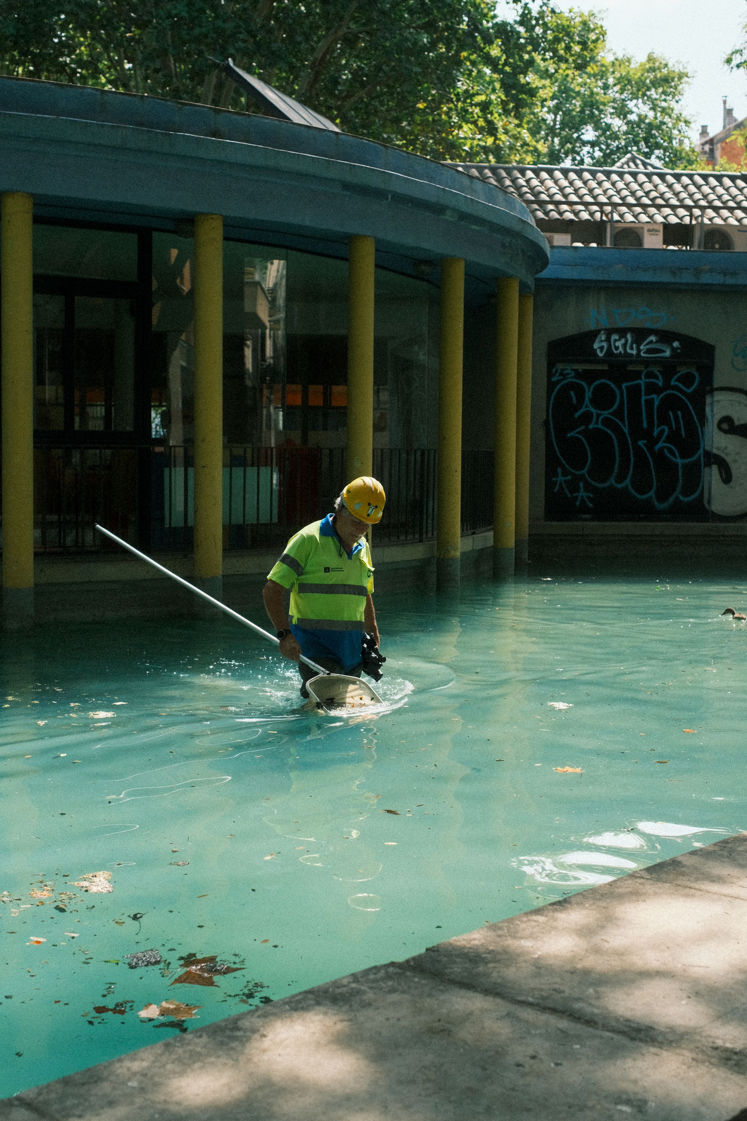 Persona realizando la limpieza de una piscina